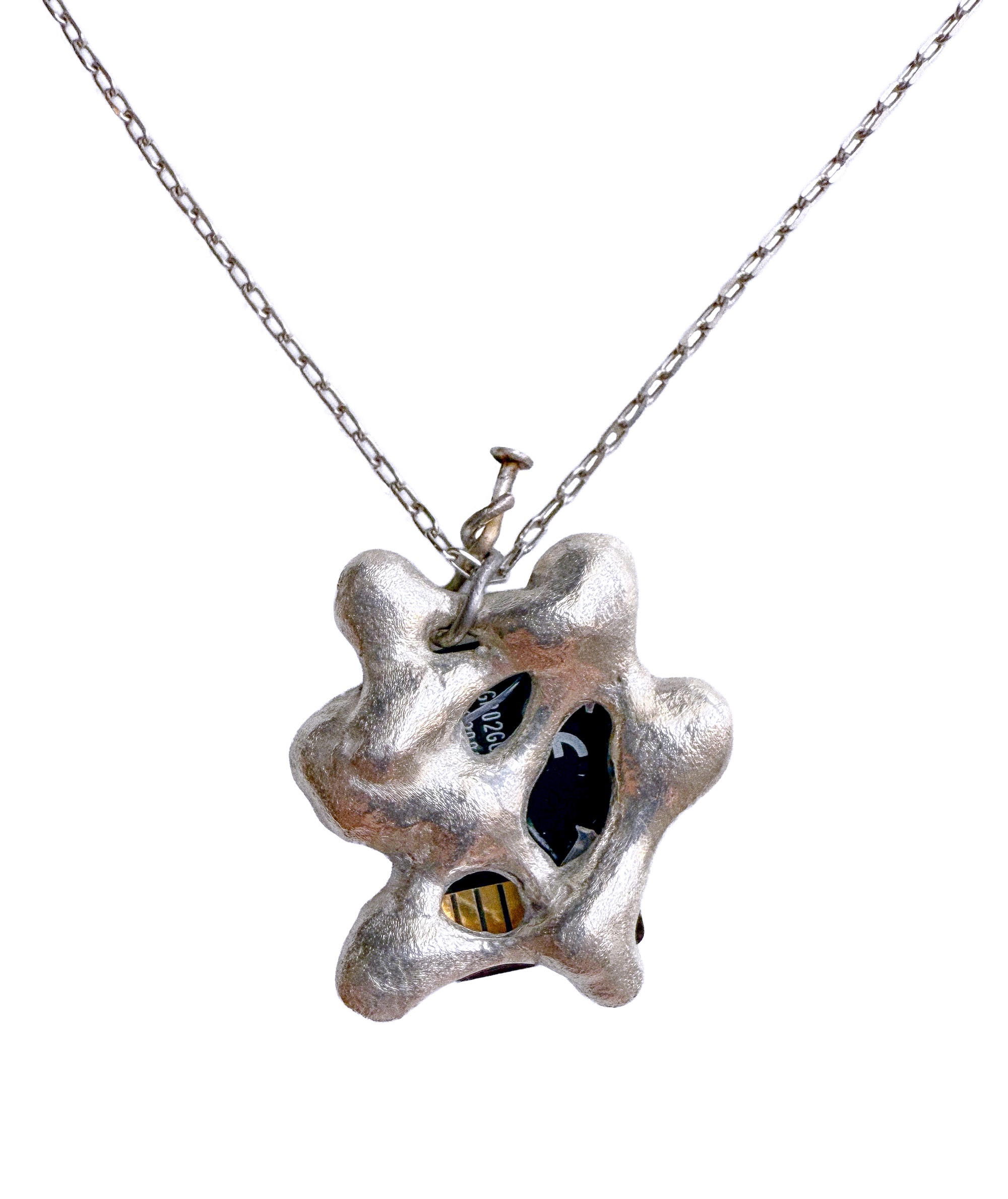 Silver locket cast around a microSD card, hung on a silver chain with a bent nail as clasp